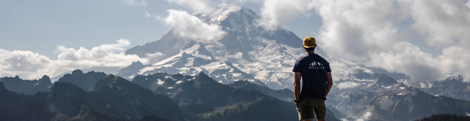 Man looking at mountain wearing best ever mountain calling t-shirt