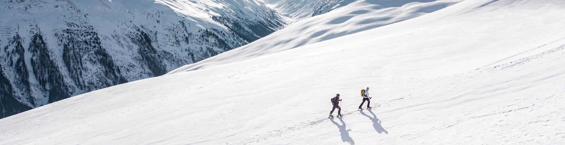 Two skiers touring up a mountain