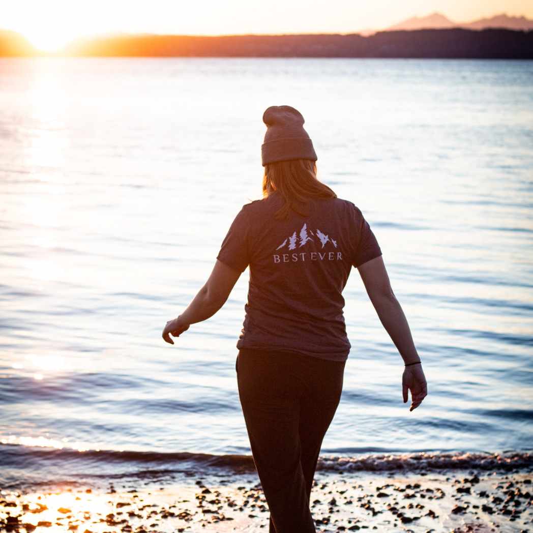 Woman on beach during sunset wearing best ever t-shirt